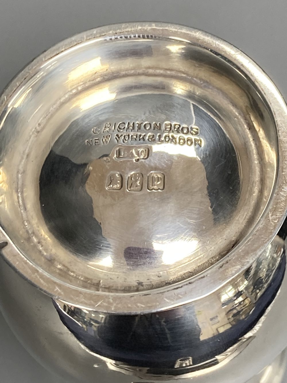 A George V Brittania standard silver sparrow beak cream jug, London, 1910 and an earlier silver two handled sugar bowl,